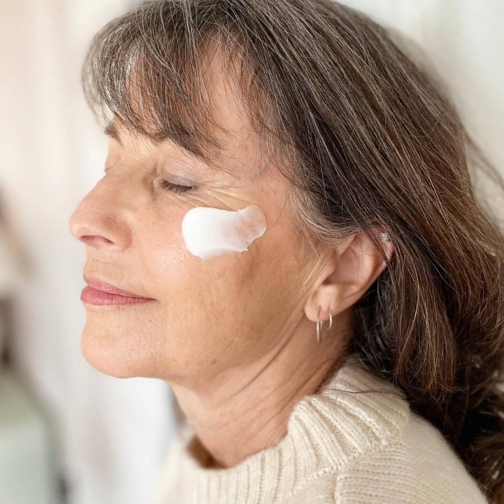 Woman applying skincare for sensitive skin to face